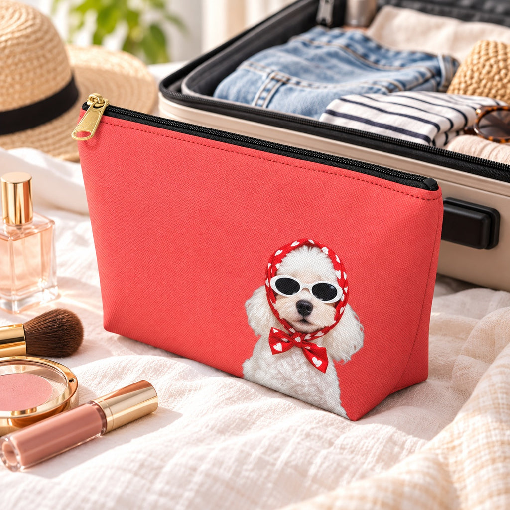 Red makeup pouch with a white Poodle in sunglasses and a red scarf inside an open suitcase