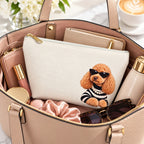 Cream makeup pouch with an apricot Poodle in sunglasses and a striped top inside a handbag