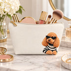 Cream makeup pouch with an apricot Poodle in sunglasses and a striped top holding makeup brushes